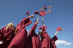 Women Throwing Hats in the Air on Graduation Day